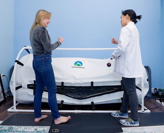 Dr. Khanita showing patient the hyperbaric oxygen chamber.